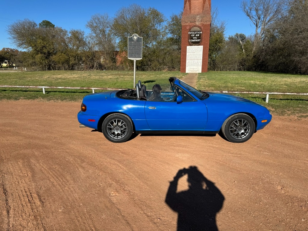 1991 Mazda Miata NA · Mariner Blue · as-is at the Evolution of an Oil Company historical marker · Texas back road
