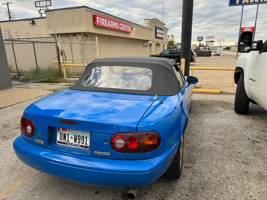 1991 Mazda Miata NA · DN1 W991 Texas plate · honest Mariner Blue patina · ready for its next chapter